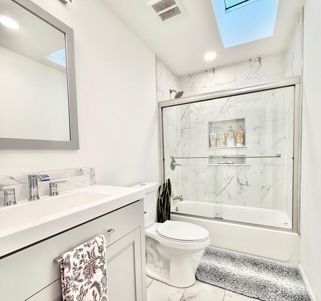 123 3rd St, Middlesex, NJ 08846 - bathroom with toilet, marble finish flooring, vanity, shower / bath combination with glass door, and a skylight