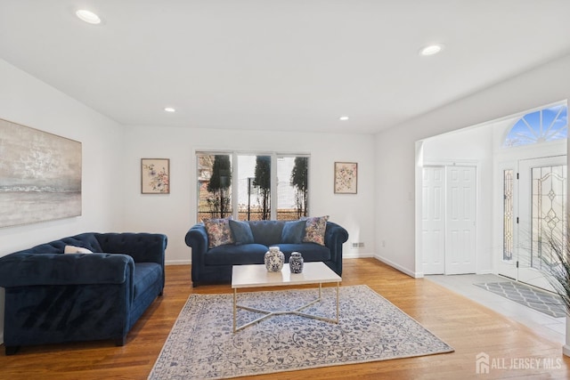 living area featuring recessed lighting, baseboards, and wood finished floors