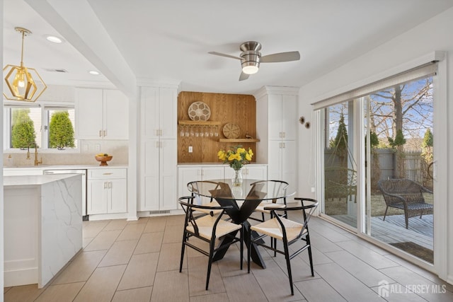 dining room featuring a ceiling fan and visible vents