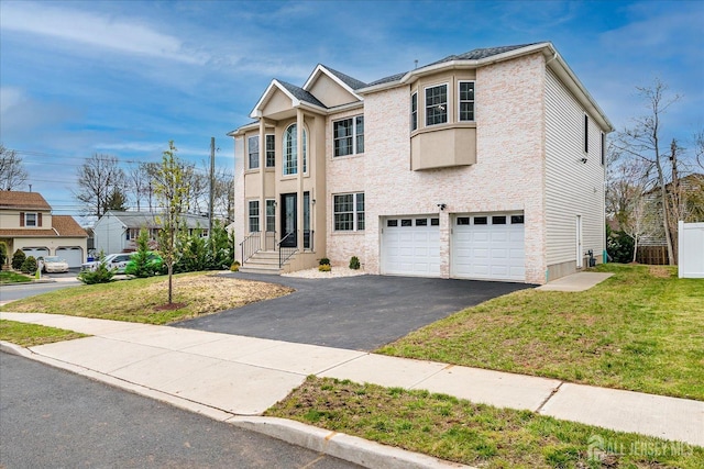 view of front of house featuring an attached garage, a front lawn, and aphalt driveway