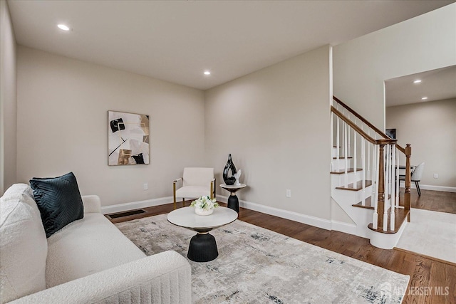 living room featuring stairway, wood finished floors, and recessed lighting