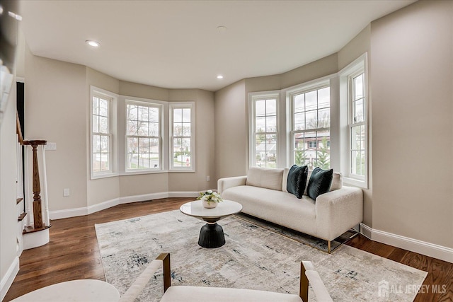 living area featuring wood finished floors, recessed lighting, visible vents, and baseboards