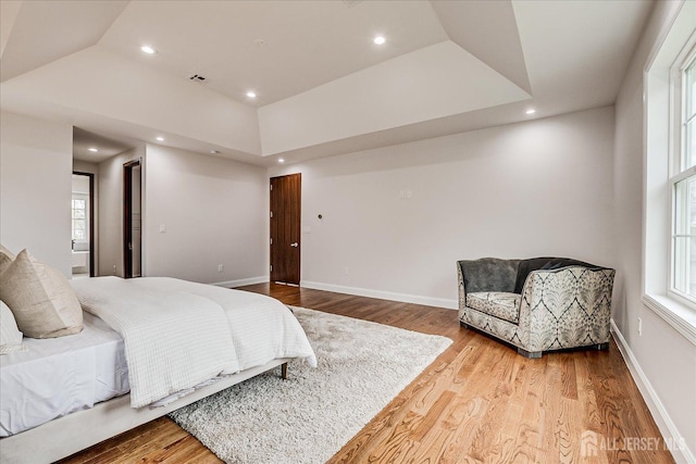 bedroom featuring visible vents, baseboards, wood finished floors, and recessed lighting