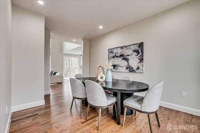 dining space featuring baseboards, recessed lighting, and light wood-style flooring