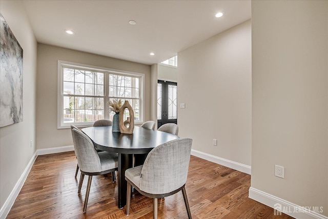dining room with a wealth of natural light, french doors, wood finished floors, and baseboards