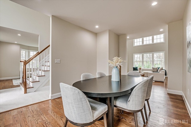 dining room with recessed lighting, baseboards, stairs, and plenty of natural light