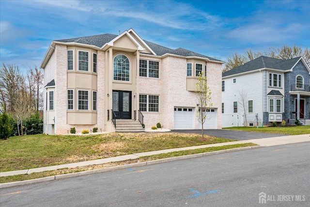 view of front of house with aphalt driveway, french doors, an attached garage, a front yard, and stucco siding