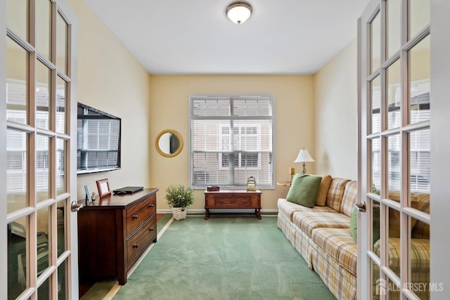 sitting room with french doors, baseboards, and carpet floors