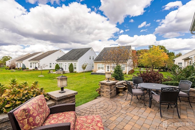 view of patio featuring a residential view and outdoor dining area