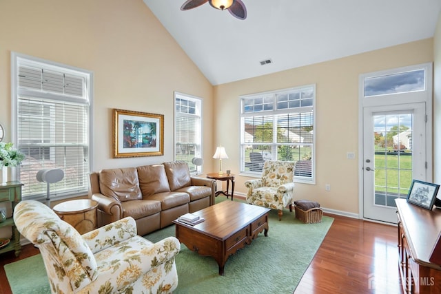 living room with visible vents, baseboards, ceiling fan, wood finished floors, and high vaulted ceiling