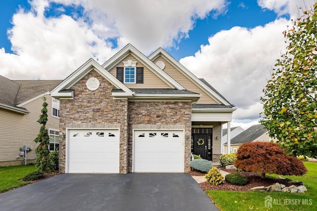 view of front of property featuring aphalt driveway, stone siding, and an attached garage