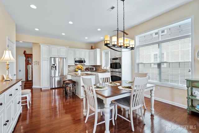 dining space with visible vents, recessed lighting, baseboards, dark wood-style floors, and a notable chandelier