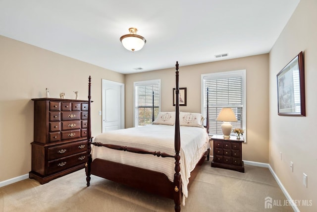 bedroom featuring light colored carpet, baseboards, and visible vents