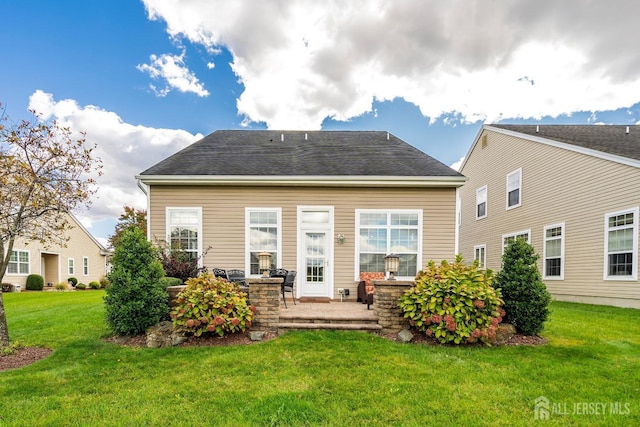 rear view of property featuring a yard and a patio area