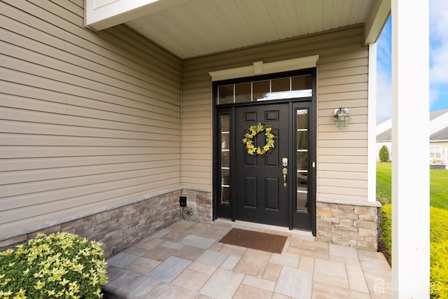 view of exterior entry with stone siding