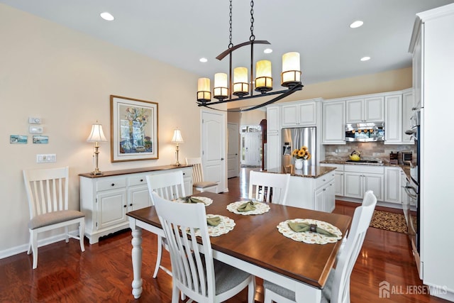 dining room featuring recessed lighting, an inviting chandelier, and dark wood finished floors