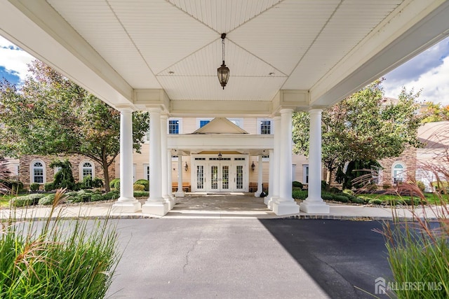 exterior space with french doors and covered porch