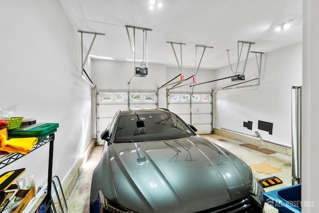 garage featuring a garage door opener and baseboards