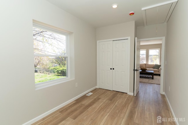 100 Cutters Dock Rd, Woodbridge Proper, NJ 07095 - unfurnished bedroom featuring attic access, light wood-type flooring, and a closet