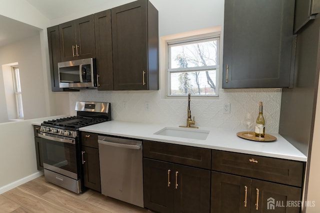 100 Cutters Dock Rd, Woodbridge Proper, NJ 07095 - kitchen with stainless steel appliances, decorative backsplash, light countertops, and light wood finished floors