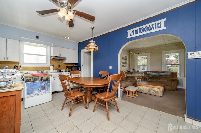 667 Seminary Ave, Rahway, NJ 07065 - dining area with arched walkways, a ceiling fan, crown molding, healthy amount of natural light, and light tile patterned floors