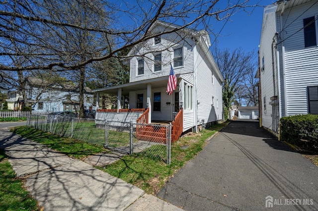 667 Seminary Ave, Rahway, NJ 07065 - view of front facade featuring a porch, a gate, a fenced front yard, and a garage