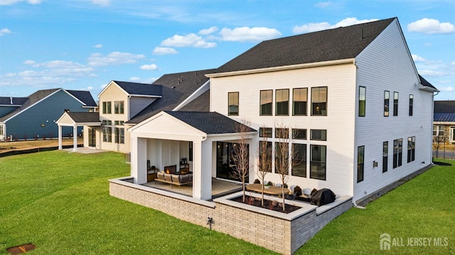 back of house featuring an outdoor living space, a yard, and a patio area