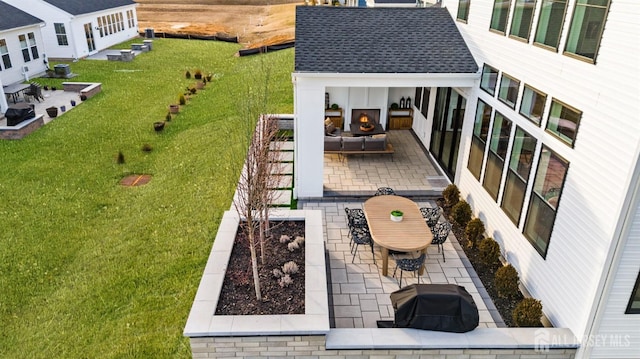 exterior space with area for grilling and an outdoor living space with a fireplace