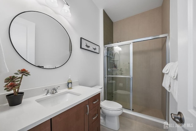 full bathroom featuring tile patterned floors, toilet, a stall shower, and vanity