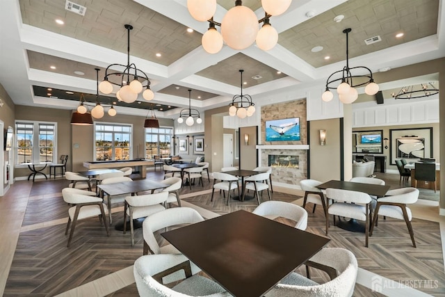 interior space with a high ceiling, a fireplace, visible vents, and coffered ceiling