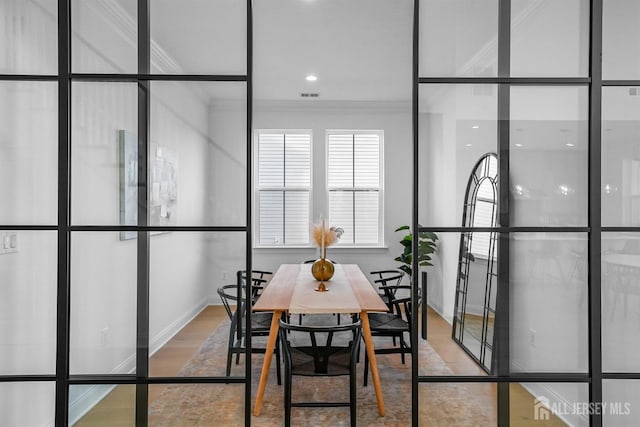 dining room featuring visible vents and crown molding