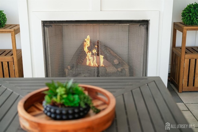 interior details featuring a lit fireplace