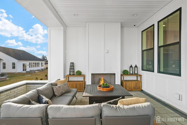 balcony with an outdoor living space with a fireplace