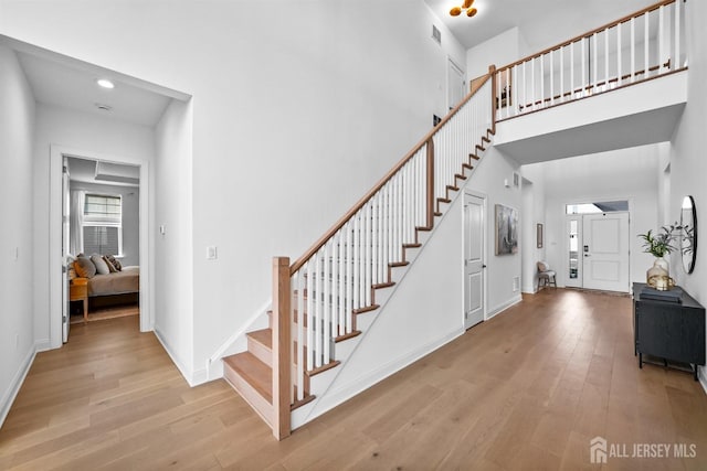 entrance foyer with light hardwood / wood-style flooring and a high ceiling