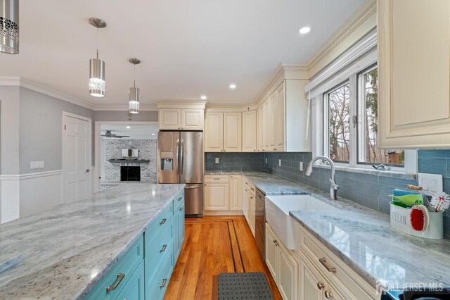 18 Back Bone Hill Rd, Millstone, NJ 08510 - kitchen with appliances with stainless steel finishes, decorative backsplash, a sink, hanging light fixtures, and light wood-style flooring