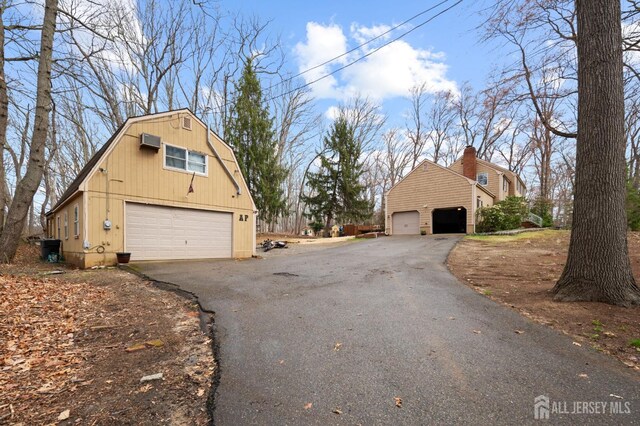 18 Back Bone Hill Rd, Millstone, NJ 08510 - view of home's exterior with a gambrel roof, a garage, an outdoor structure, and asphalt driveway
