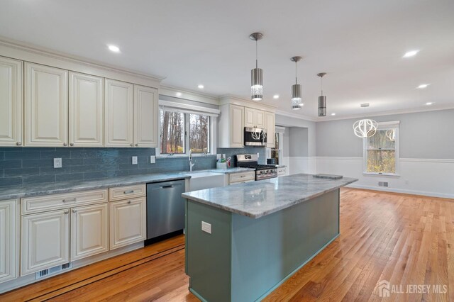 18 Back Bone Hill Rd, Millstone, NJ 08510 - kitchen with appliances with stainless steel finishes, a sink, light wood-style floors, plenty of natural light, and ornamental molding