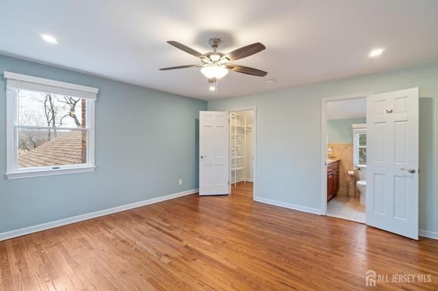 18 Back Bone Hill Rd, Millstone, NJ 08510 - unfurnished bedroom with a walk in closet, baseboards, light wood-type flooring, ensuite bath, and a closet