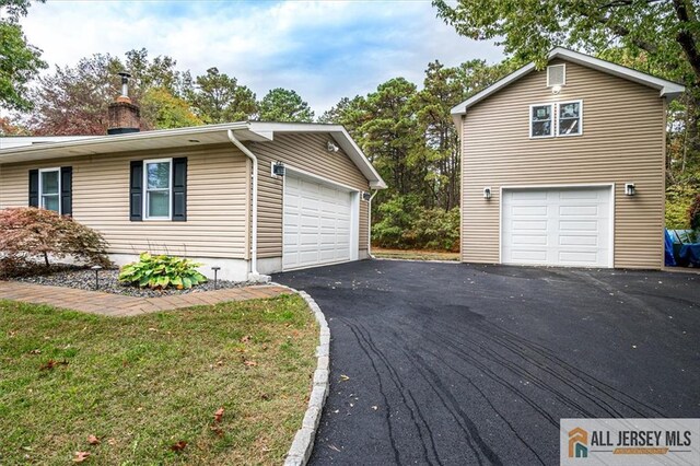 view of property exterior with a yard and a garage