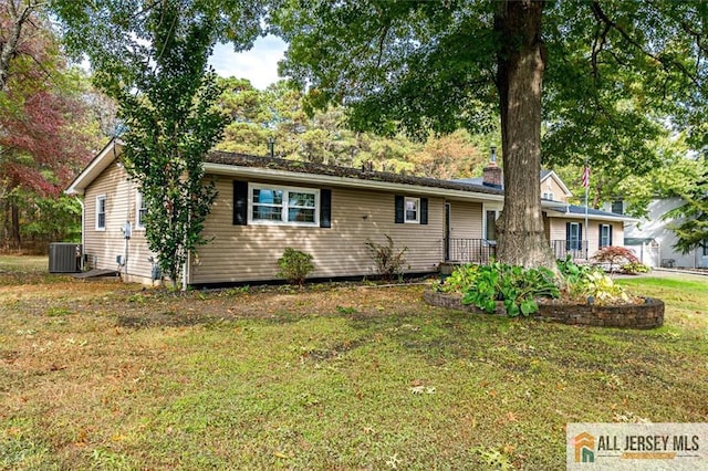 ranch-style home featuring central AC and a front lawn