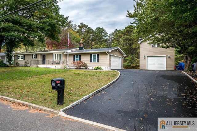 ranch-style home with a garage and a front lawn