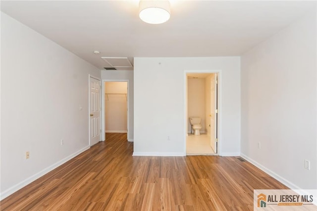 199 Pinelli Dr, Piscataway, NJ 08854 - unfurnished bedroom featuring light wood-style flooring, a spacious closet, and ensuite bath
