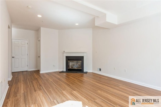 199 Pinelli Dr, Piscataway, NJ 08854 - unfurnished living room with light wood-style floors, a glass covered fireplace, and recessed lighting