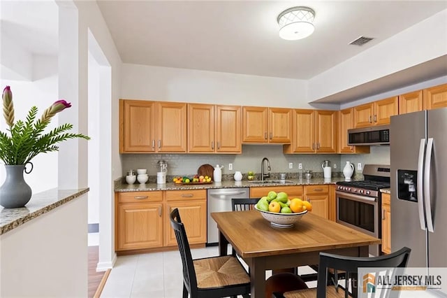 199 Pinelli Dr, Piscataway, NJ 08854 - kitchen featuring stainless steel appliances, light stone counters, tasteful backsplash, and light tile patterned flooring