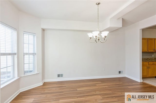 199 Pinelli Dr, Piscataway, NJ 08854 - unfurnished dining area with light wood-type flooring and a chandelier