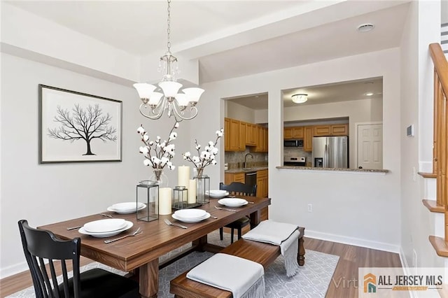 199 Pinelli Dr, Piscataway, NJ 08854 - dining area featuring a chandelier and wood finished floors