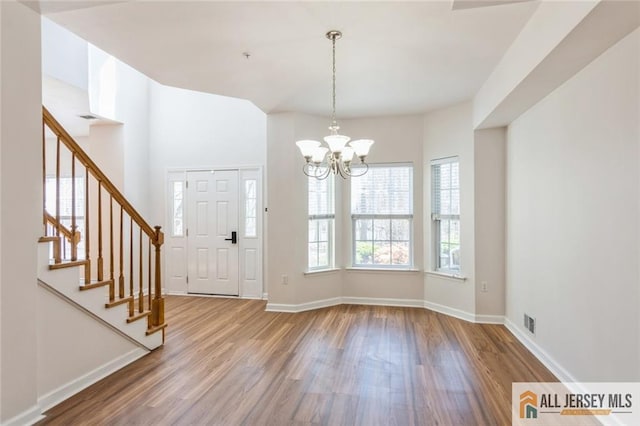 199 Pinelli Dr, Piscataway, NJ 08854 - foyer entrance featuring wood finished floors, stairs, and a chandelier