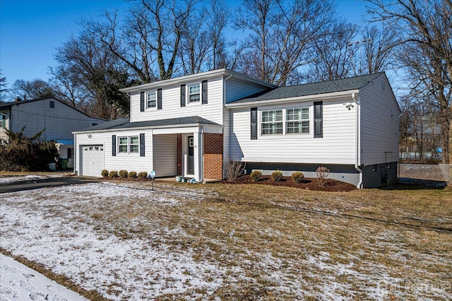 view of front facade with aphalt driveway and an attached garage