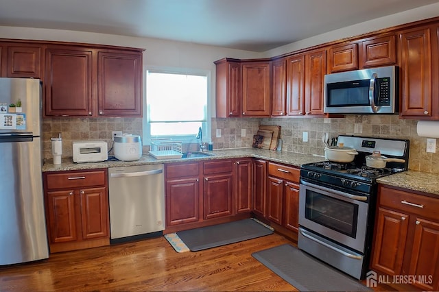 202 Jackson Ave, Edison, NJ 08837 - kitchen with stainless steel appliances, backsplash, and light wood-style floors