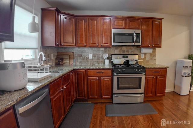 202 Jackson Ave, Edison, NJ 08837 - kitchen featuring appliances with stainless steel finishes, wood finished floors, a sink, light stone countertops, and tasteful backsplash
